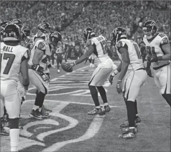  ?? ASSOCIATED PRESS FILE PHOTO ?? Atlanta Falcons wide receiver Mohamed Sanu (12) leads teammates in a dance in the end zone after scoring a touchdown against the Seahawks in Seattle on Nov. 20.