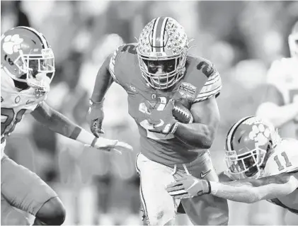  ?? CHRISTIAN PETERSEN/GETTY ?? Ohio State’s J.K. Dobbins carries the ball against Clemson during the College Football Playoff semifinal at the Fiesta Bowl on Dec. 28.