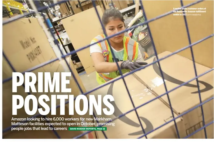  ?? GETTY IMAGES FILE ?? A worker packs customer orders at the Romeoville Amazon fulfillmen­t center in 2017.