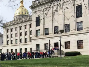  ?? JOHN RABY — THE ASSOCIATED PRESS FILE ?? Striking West Virginia teachers line up to enter the state Capitol in Charleston, W.Va. In a state not known as a friend to labor unions, hundreds of West Virginia teachers found a way to organize a massive nine-day strike that paved the way to raises...