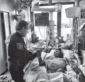  ??  ?? Sheriff Israel visits Anthony Borges, 15, in the hospital. His family informed the media that he was shot five times in Wednesday’s school attack. (Photo: Scoopnest)