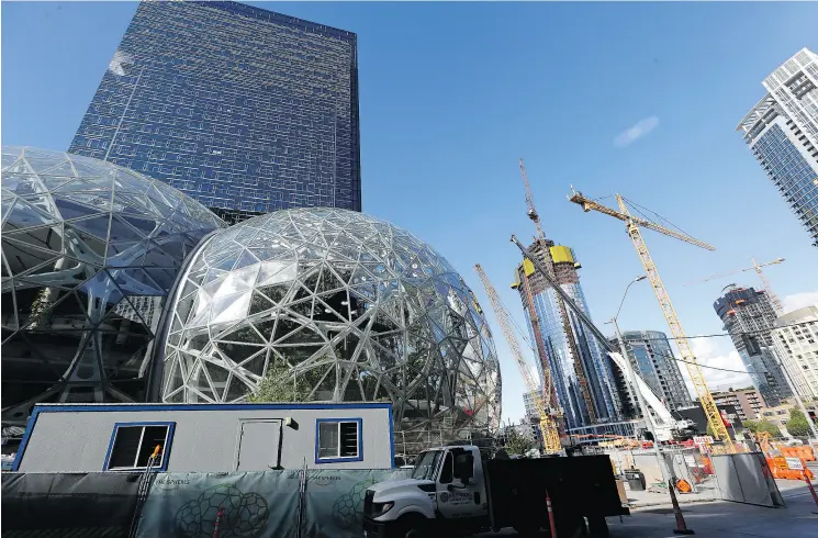  ?? ELAINE THOMPSON / THE ASSOCIATED PRESS FILES ?? Amazon opened a headquarte­rs in Seattle’s South Lake Union district in 2010 that has expanded eightfold. Today, everywhere you look in Seattle are signs of a thriving city.