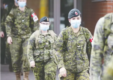  ?? CHRISTINNE MUSCHI / BLOOMBERG FILES ?? Canadian Armed Forces medical personnel leave after a shift at the Centre Valeo St. Lambert long-term care home in St. Lambert, Que., in April.