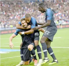  ??  ?? France’s forward Olivier Giroud celebrates with teammates after scoring a goal during the UEFA Nations League football match between France and Netherland­s at the Stade de France stadium, in Saint-Denis, northern of Paris. — AFP photo