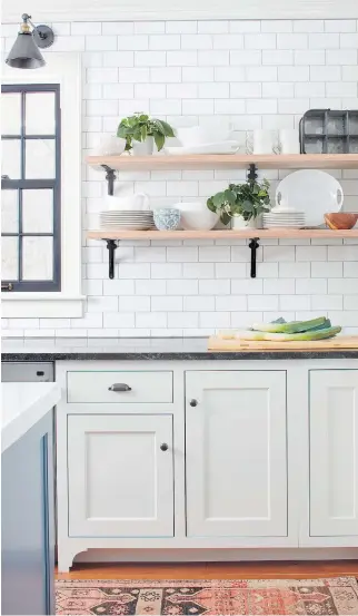  ??  ?? Designer Kristina Crestin uses fresh plants to add colour to this monochrome kitchen.