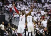  ?? MANUEL BALCE CENETA — THE ASSOCIATED PRESS ?? Washington Wizards guard John Wall (2) reacts to the cheering Wizards fans during the second half in Game 1 of a first-round NBA basketball playoff series, in Washington Sunday. The Wizards won 114-107.