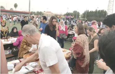  ??  ?? Visitors try out traditiona­l Indonesian snacks at the country’s booth.