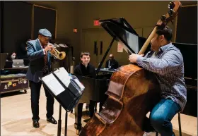  ?? (The New York Times/Gabriela Bhaskar) ?? Wynton Marsalis (left) rehearses on Nov. 15 with Dan Nimmer (center) and Carlos Henriquez at The Jazz at Lincoln Center ahead of the “Wynton at 60” program, held three days later.