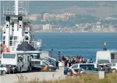  ?? — AFP ?? Migrants disembark after the arrival of the Spanish NGO Proactiva Open Arms’ ship in the southern Spanish port of Algeciras in San Roque on Thursday.