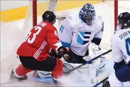  ?? FRANK GUNN, THE CANADIAN PRESS ?? Team Canada’s Brad Marchand, left, scores on Team Europe goaltender Jaroslav Halak in World Cup of Hockey final action in Toronto on Tuesday night. Canada also got goals from Patrice Bergeron and Steven Stamkos in the first game of the best-of-three...