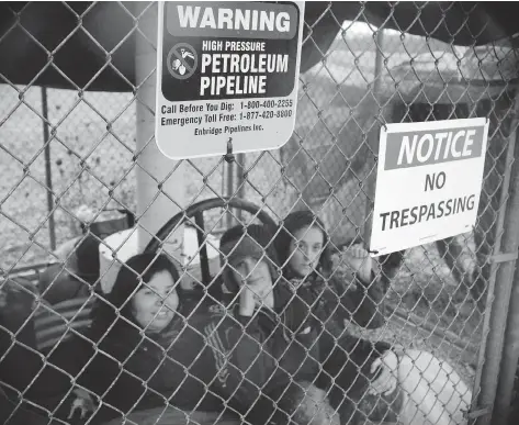  ?? THE CANADIAN PRESS ?? Enbridge’s Line 9 pipeline was off-line for about 90 minutes last month after three activists locked themselves to a valve site on the outskirts of Sarnia, Ont. The anti-pipeline movement is emboldened by recent wins like the U.S. rejection of the...