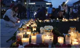  ?? ?? People place flowers and candles in Kongsberg, Norway, on Thursday evening after the bow and arrow attack that left five dead. Photograph: Terje Bendiksby/AP