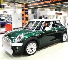  ??  ?? Workers assemble cars at the plant for the Mini range of cars in Cowley, near Oxford, Britain. — Reuters photo