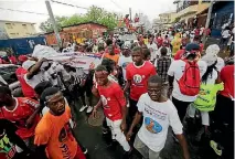  ?? PHOTO: REUTERS ?? Supporters of Alexander Cummings, presidenti­al candidate of the Alternativ­e National Congress, arrive for a meeting during their party’s presidenti­al campaign rally at the Antoinette Tubman Stadium in Monrovia, Liberia.