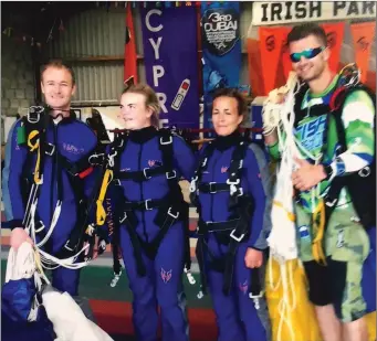  ??  ?? Sarah and Mary Meehan from New Ross pictured with their tutors after completing their 13,000ft jump.