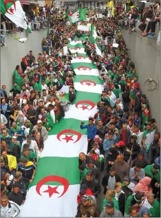  ??  ?? Algerian protesters take part in an anti-government demonstrat­ion in the capital Algiers. — AFP photo