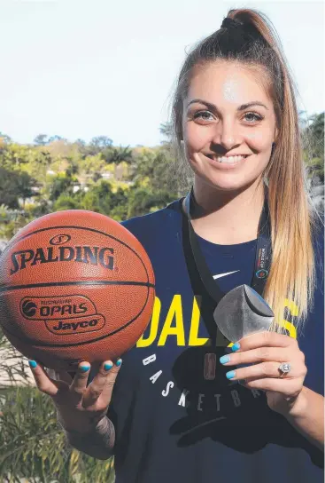  ?? Picture: JUSTIN BRIERTY ?? SILVER LINING: Cairns hoops star Cayla George shows off her World Cup medal.