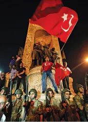  ?? — AP ?? Turkish soldiers ( left) secure the area as supporters of Turkey’s President Recep Tayyip Erdogan protest in Istanbul’s Taksim Square. A tank ( right) moves into position as Turkish people attempt to stop it in Ankara on Saturday.