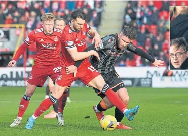  ?? ?? Aberdeen’s Connor Mclennan and United’s Calum Butcher tussle for possession