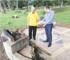  ??  ?? Goh (right) shows Ting some sections of Tanjong Lobang areas that need some repairs and upgrading.