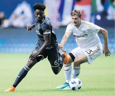  ?? DARRYL DYCK/THE CANADIAN PRESS ?? The Vancouver Whitecaps’ Alphonso Davies, left, seen in action last month, has been an inspiratio­n for the Whitecaps this season, bringing “energy off the bench,” according to head coach Carl Robinson. They’ll need all that and more against Minnesota...