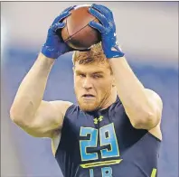  ?? AP PHOTO ?? Wisconsin linebacker T.J. Watt makes a catch as he runs a drill at the NFL scouting combine in Indianapol­is on Sunday.