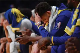  ?? JOSE CARLOS FAJARDO — BAY AREA NEWS GROUP, FILE ?? The Warriors’ Klay Thompson (11) sits dejected on the bench as the final seconds wind down during the fourth quarter of Game 6of a Western Conference semifinal at Crypto. com Arena in Los Angeles on May 12.