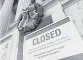  ?? ANDREW CABALLERO-REYNOLDS/GETTY-AFP ?? A sign is displayed Saturday at the National Archives, which is closed because of a government shutdown.