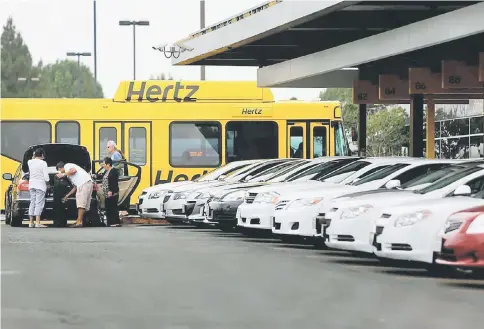  ??  ?? Hertz Rental Cars shuttle buses transport passengers to the Hertz rental location at Los Angeles Internatio­nal Airport in Los Angeles on July 26, 2013. — WP-Bloomberg photo