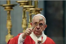  ?? GREGORIO BORGIA — THE ASSOCIATED PRESS ?? Pope Francis asperges holy water as he celebrates a Pentecost Mass in St. Peter’s Basilica at the Vatican on Sunday.