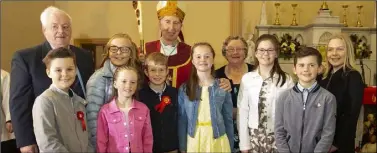  ??  ?? Bishop Denis Brennan with Paddy and Bridget English and their eight grandchild­ren who were confirmed.