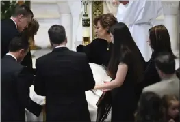  ?? TODD MCINTURF — DETROIT NEWS VIA AP ?? Family members, including mother Mary “Mia” Fraser, center right, place the pall on the casket of Brian Fraser as family members, friends and supporters gather during the funeral mass for Brian Fraser at St. Paul on the Lake Catholic Church in Grosse Pointe Farms, Mich., on Saturday.