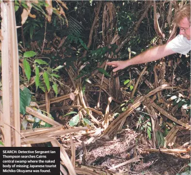  ??  ?? SEARCH: Detective Sergeant Ian Thompson searches Cairns central swamp where the naked body of missing Japanese tourist Michiko Okuyama was found.