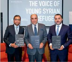  ?? A Voice For Young Syrian Refugees.— Supplied photo ?? Sunil John (left) and other officials releasing