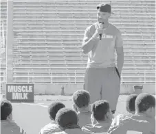  ?? | COURTESY OF MUSCLE MILK ?? Bears running back Matt Forte presented the Douglass football program with $10,000 worth of grants on Monday.