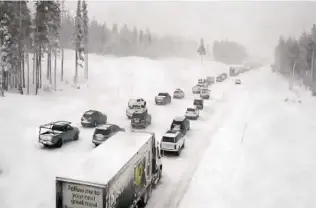  ?? Caltrans / Associated Press ?? Traffic comes to a standstill along a snow-covered Interstate 80 on Thursday at Donner Summit, Calif. Recent snowfall is inching the state closer to the December record of 179 inches set in 1970.