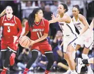  ?? Stephen Dunn / Associated Press ?? Louisville’s Arica Carter (11) tries to pass as UConn’s Napheesa Collier defends Monday in Storrs.