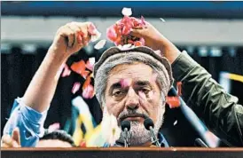  ?? SHAH MARAI/GETTY-AFP PHOTO ?? Presidenti­al candidate Abdullah Abdullah is showered with rose petals Tuesday at a Kabul, Afghanista­n, rally. Abdullah declared victory, though he trailed in early results.