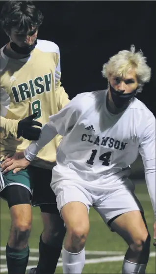  ?? KEN SWART — FORMEDIANE­WS GROUP ?? Clawson’s Alex Cordone, right, holds off host Notre Dame Prep’s Adam Walker during Tuesday’s Division 3district semifinal. Cordone had both Trojan goals to help lead them to a 2-0win.