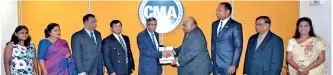  ??  ?? CMA Sri Lanka President Prof. Lakshman R. Watawala congratula­tes and hands over a copy of the MOU to NIOE President Dr. Jagath Peiris in the presence of (on the left) CMA Council Member Adrian Perera, CMA CEO Kanishka Jayasinghe, CMA Senior Director...