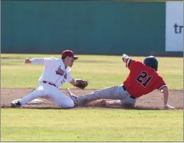  ?? MATT BATES — ENTERPRISE-RECORD ?? Chico State’s Jeffrey Ray attempts to tag out Saint Martin’s runner Cody Chavis on Feb. 4, 2022, in Chico.