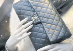  ??  ?? A Chanel leather clutch bag.