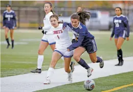  ?? ?? Las Cruces’ Lyla Nielsen, left, collides with Santa Fe High’s Allison Segura-Maze during the first half of Tuesday’s match. The Demons’ offensive line didn’t come to life until the final 10 minutes of regulation but was still unable to fight past Las Cruces’ defense.