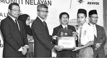  ??  ?? Ahmad (second left) presenting the award to a recipient, witnessed by Raisin (third right), Hasbollah (right) and Eddie.