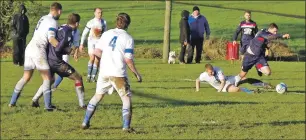  ??  ?? Donald Campbell is sent sprawling in the box by Evan Armstrong for Saints first penalty of the match.