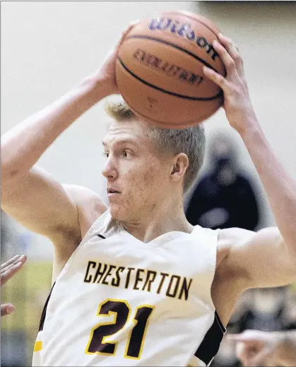  ?? MICHAEL GARD/POST-TRIBUNE ?? Chesterton’s Chris Mullen looks to pass Friday gainst Crown Point. He made a key dive for a loose ball late in the game to help the Trojans win.