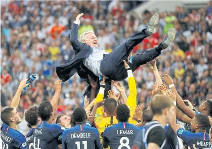  ?? REUTERS ?? LEFT France coach Didier Deschamps is tossed by his players.