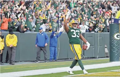  ?? ASSOCIATED PRESS ?? Green Bay Packers running back Aaron Jones celebrates his game-winning touchdown run during overtime against the Tampa Bay Buccaneers on Sunday at Lambeau Field.