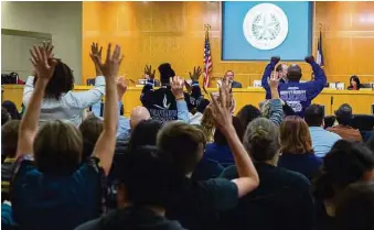  ?? Mark Mulligan / Houston Chronicle ?? Crowd members agree with a speaker Thursday evening at a Houston ISD school board meeting.