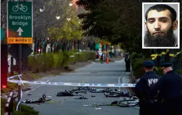  ??  ?? Path of terror: Policemen cordoning off the crime scene where Saipov (inset) allegedly struck in New York City. — Agencies